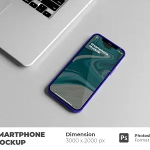 PSD Mockup Perspective Smartphone Device, Smartphone with blue frame lying on gray surface next to laptop keyboard