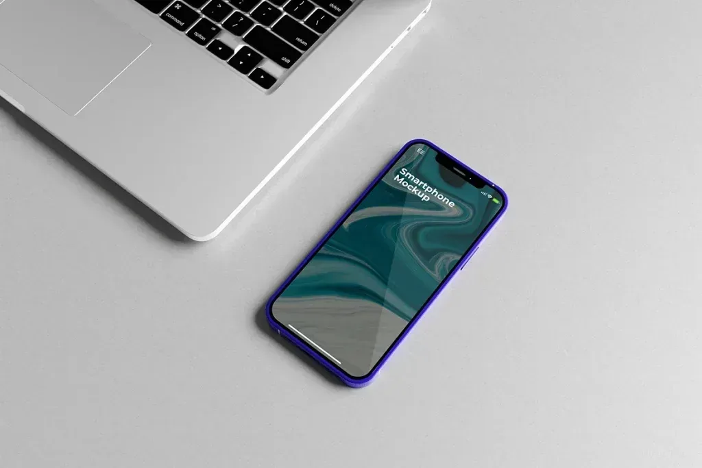 PSD Mockup Perspective Smartphone Device, Smartphone with blue case lying on gray surface near laptop keyboard