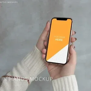 PSD Mockup iPhone 12 Pro, iPhone 12 Pro held by woman with beige sweater on gray background