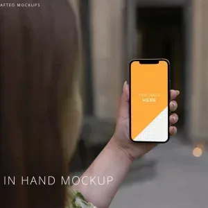 PSD Mockup iPhone 12 Pro, Woman holding iPhone 12 Pro with blank screen outdoors