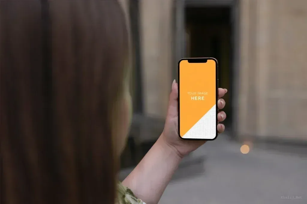 PSD Mockup iPhone 12 Pro, Woman holding iPhone 12 Pro with blank screen outdoors