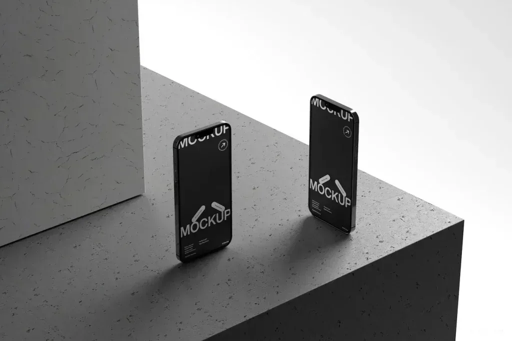 PSD Mockup Modern Dual Smartphone, Two modern smartphones standing on textured gray surface with black screens