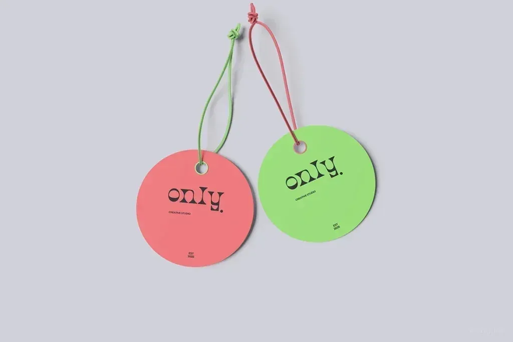 PSD Mockup Clothing Label Design, Two round clothing labels in pink and green with string attachments