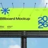PSD Mockup Billboard for City, Large roadside billboard with a neon green poster, blue 2026 text, and a sky background