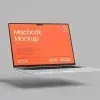PSD Mockup Laptop on Wooden, Floating laptop mockup with an orange screen on a plain gray background