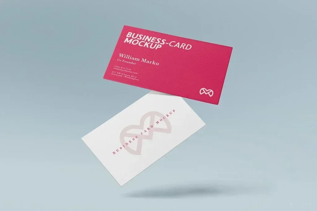 PSD Mockup Realistic Business Card, Two floating business cards on a light blue background, one pink and one white