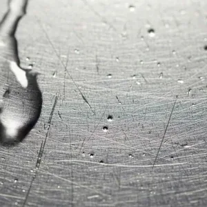 Macro Water Droplets Sliding Down Scratched Metal Stock Footage Macro Water Droplets Sliding Down Scratched Metal Stock Footage