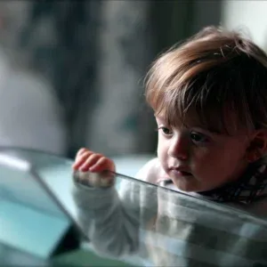 Young Boy Focused on Tablet Indoors Stock Footage Young Boy Focused on Tablet Indoors Stock Footage