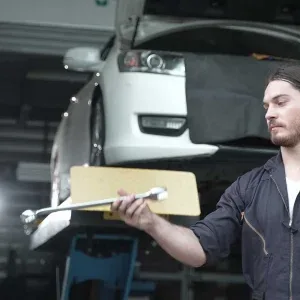 Mechanic Tossing Wrench in Auto Shop Stock Footage Mechanic Tossing Wrench in Auto Shop Stock Footage