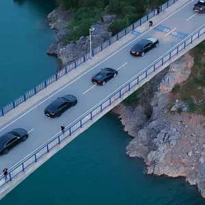 Luxury Car Convoy on Scenic Bridge Stock Footage Luxury Car Convoy on Scenic Bridge Stock Footage