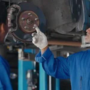 Mechanics Discussing Brake Repairs Stock Footage Mechanics Discussing Brake Repairs Stock Footage
