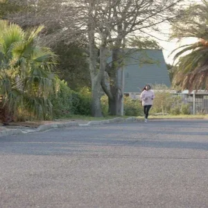 Woman Jogging Golden Hour Suburb Stock Footage Woman Jogging Golden Hour Suburb Stock Footage