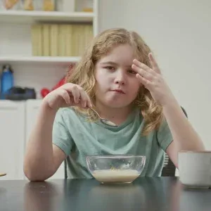 Girl Eating Cereal at Table Stock Footage Girl Eating Cereal at Table Stock Footage
