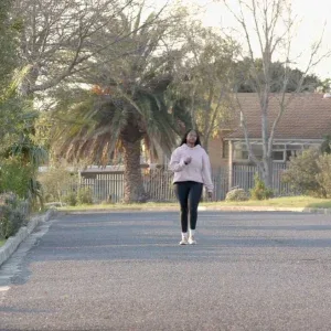 Woman Walking Suburban Golden Hour Stock Footage Woman Walking Suburban Golden Hour Stock Footage